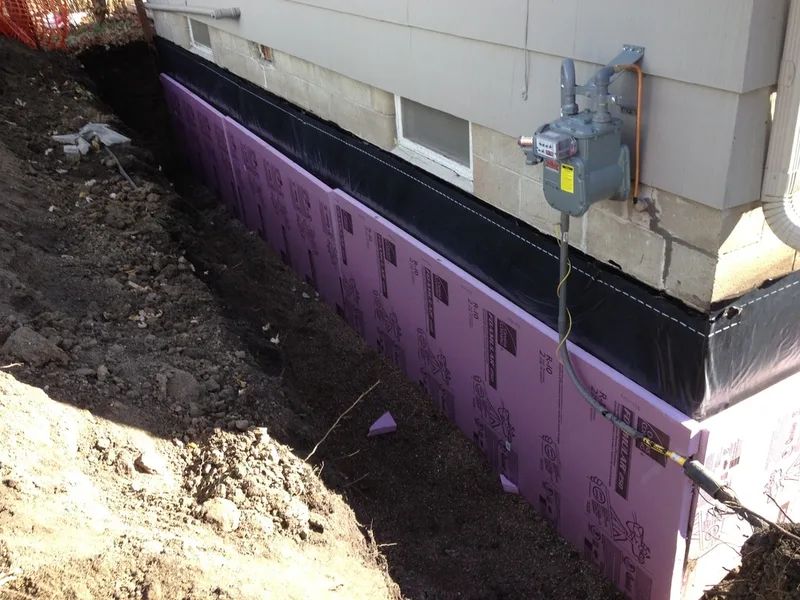 Installing insulation foam to block walls.