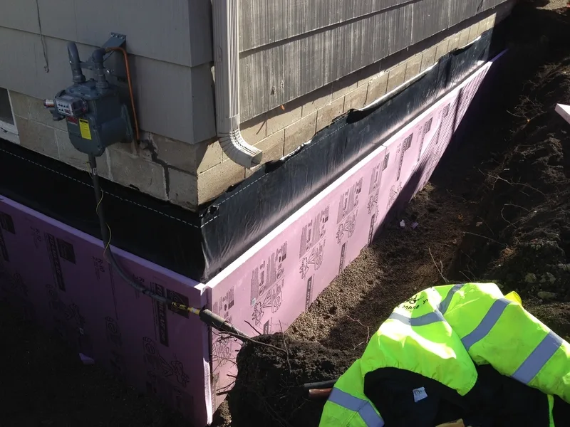 Installing insulation foam to block walls.